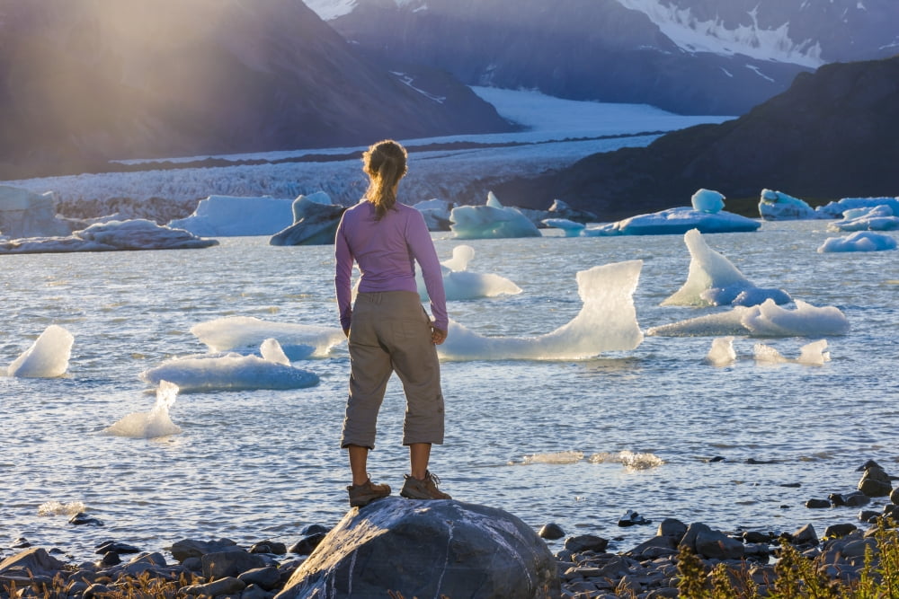 Woman standing on a rock overlooking an iceberg filled bear glacier lake at sunset kenai fjords national park in summertimeAlaska united states of america Canvas Art - Michael DeYoung Design Pics (17