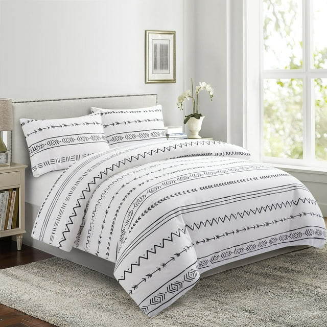 white duvet cover set with black simplified modern geometric pattern on bed in bright room
