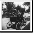 thumbnail image 2 of Historic Framed Print, [Unidentified boy driving an early automobile; woman seated alongside him], 17-7/8" x 21-7/8", 2 of 9