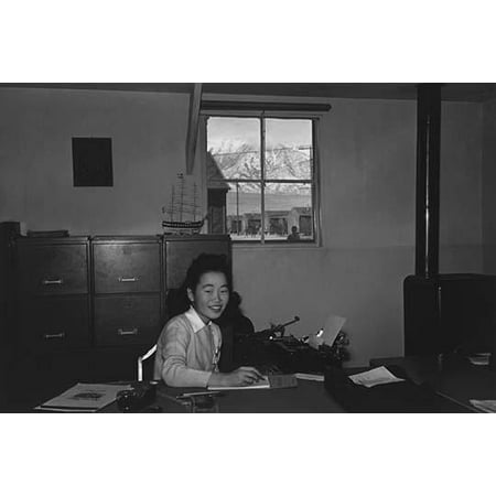 Yoshiko Joan Mori half-length portrait seated at a desk in an office facing slightly right holding a pen in her right hand over a steno pad  Ansel Easton Adams was an American photographer best