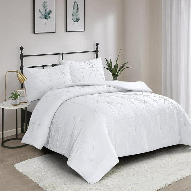 3-piece Hartford white pintuck comforter set with subtle geometric stitching displayed on a black metal bed frame in a bright, minimalist bedroom.