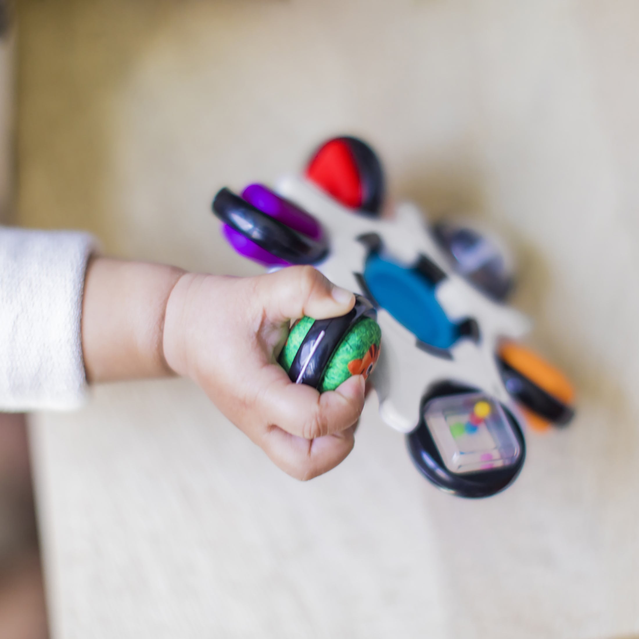 Baby Einstein Curiosity Clutch Twist and Pop Rattle Teether Infant Toy for Discovering Textures, Colors, Shapes, 3 Months+