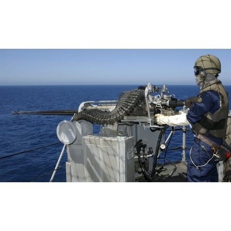 A US Navy Gunners Mate firing a 50-caliber machine gun during weapons training aboard USS Boxer Stretched Canvas - Stocktrek Images (37 x
