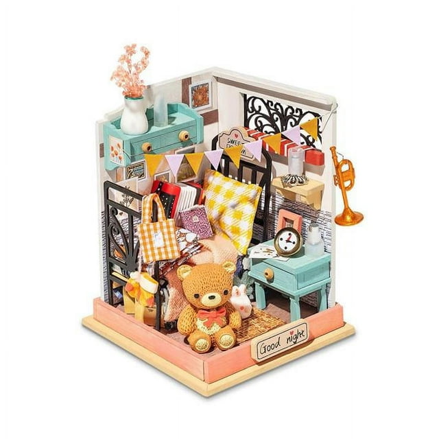 Sweet Dream - Rolife DIY Miniature Dollhouse Craft Kit for Adults and Teens to Build DS016. A multicolour miniature dollhouse featuring intricate details such as a teddy bear, a rabbit, a small bedside table, and decorative items like bunting, a trumpet, and a vase with flowers. The compact design measures 69 x 69 x 104 mm, making it ideal for beginners or experienced crafters seeking a portable project.