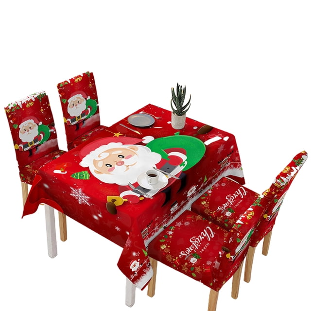 para navideña, para sillas de comedor, impermeables, para sillas de papá noel lavables, mantelería navideña pa sunnimix manteles Mantel rectangular 140x180cm en rojo con gran ilustración central de Papá Noel y patrones de copos de nieve, fibra de poliéster; incluye fundas de silla a juego; vista 3/4 de mesa montada con platos, taza y planta decorativa, indicado para decoración de hogar, cafetería y eventos navideños.