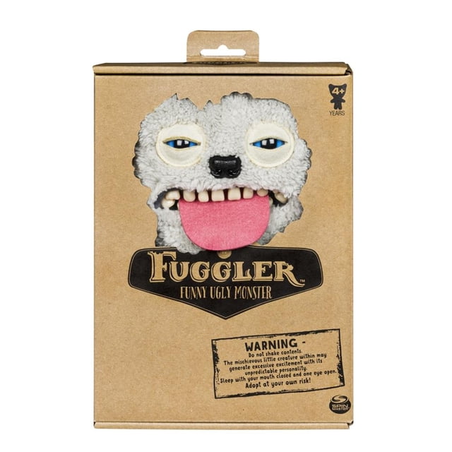 muñeco spin master fugglers 6043983 bi 24.4 cm Peluche Fuggler de 24.4 cm en empaque de cartón, vista frontal del rostro con fieltro gris texturizado, ojos azules entrecerrados, nariz negra, lengua rosa sobresaliendo y dientes espeluznantes visibles; marca Spin Master Games en la caja; recomendado 4+ años. Suele usarse como figura de colección o adorno en estantes de juguetes.