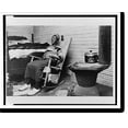 thumbnail image 2 of Historic Framed Print, [Elderly African American woman seated on rocking chair, at foot of bed, next to stove, in North Carolina].Billy Barnes for the North Carolina Fund., 17-7/8" x 21-7/8", 2 of 9