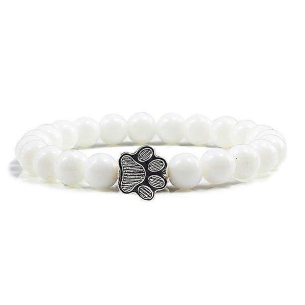 Pulsera con dije de huella de pata de piedra volcánica de lava negra mate natural, ideal como recuerdo para mascotas, amantes de los gatos y los perros.