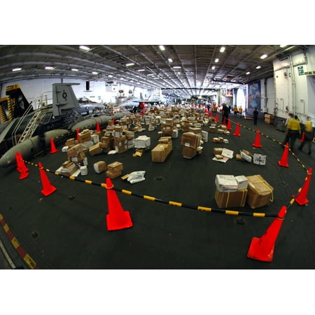 - More than 30,000 pounds of mail is arranged for sorting in the hangar bay of the aircraft carrier US Poster Print 24 x 36