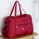 thumbnail image 1 of Bolsa de viaje plegable | Equipaje de mano deportivo para mujeres y niñas | Nailon resistente al agua | Capacidad de 25 l | Bolsa de fin de semana ligera y plegable | Negro, azul marino, gris y vino, 1 of 7