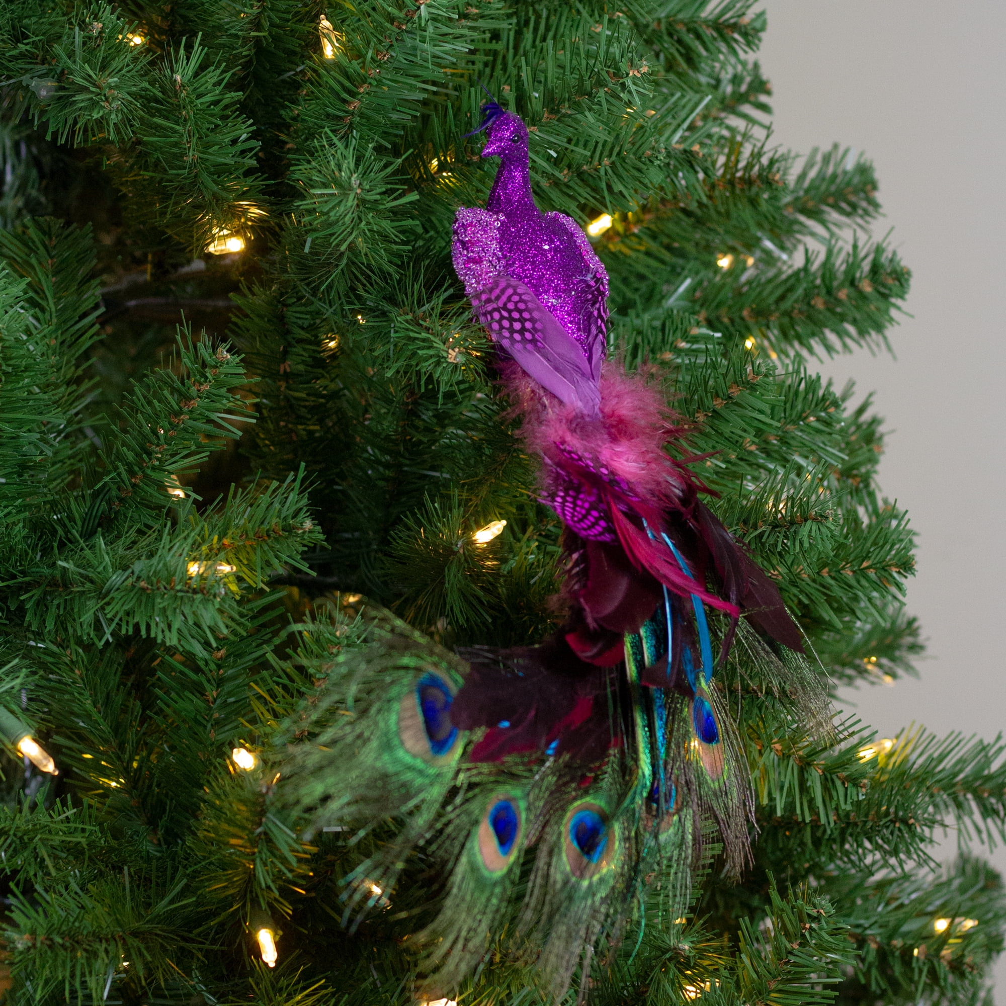 Christmas Decorations in Purple and Gold with Peacock Feather, Lights and  Balls in a Christmas Tree Stock Photo - Image of holiday, season: 184569826