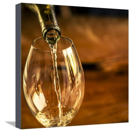 USA, Washington State, Seattle. White wine pouring into glass in a Seattle winery. Stretched Canvas Print Wall Art By Richard