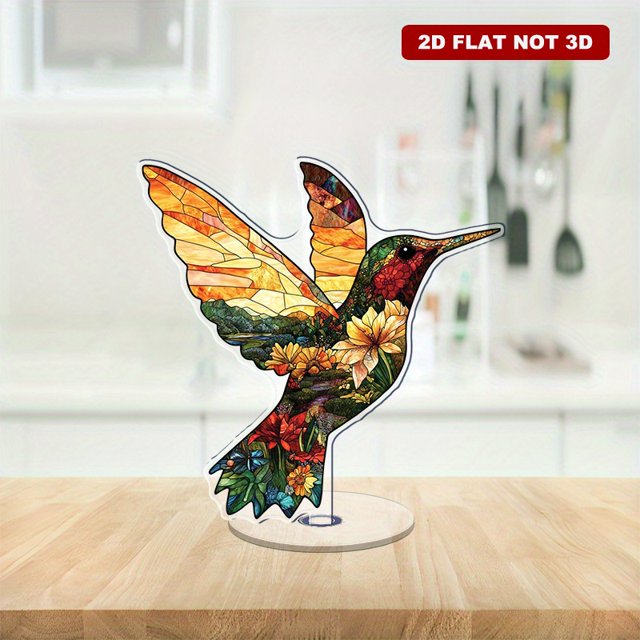Rotating acrylic ornament featuring a silhouette of a hummingbird in flight, capturing dynamic movement and elegance