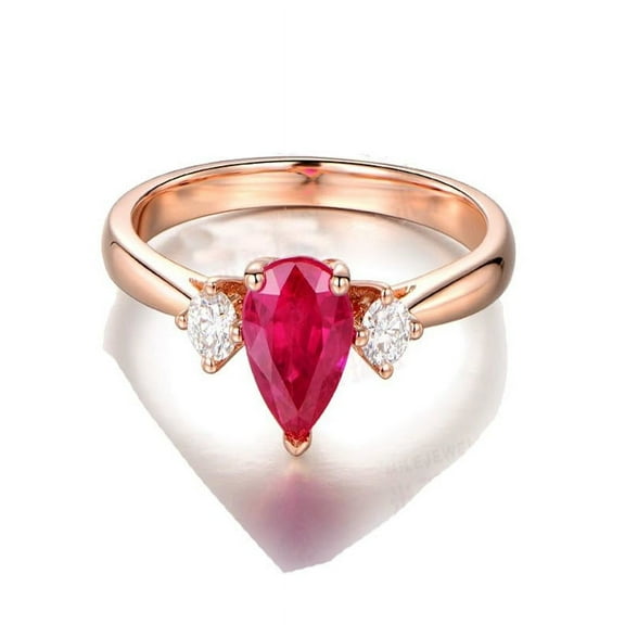 Trilogy Half Carat Pear Shape Ruby and Round Diamond Engagement Ring in Rose Gold