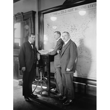 Meteorologists At The U.S. Weather Bureau Stand In Front Of A Map Of