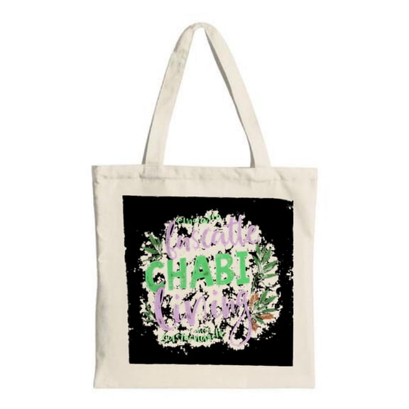 Colorful Canvas Tote Bag with " I'm so happy I'm not a chart maker " design surrounded by green leaves on a black background