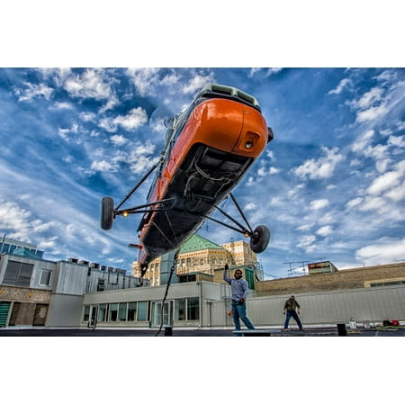An S-58T picks up the lifting line on the top of a building in Chicago Illinois Poster Print by Rob EdgcumbeStocktrek