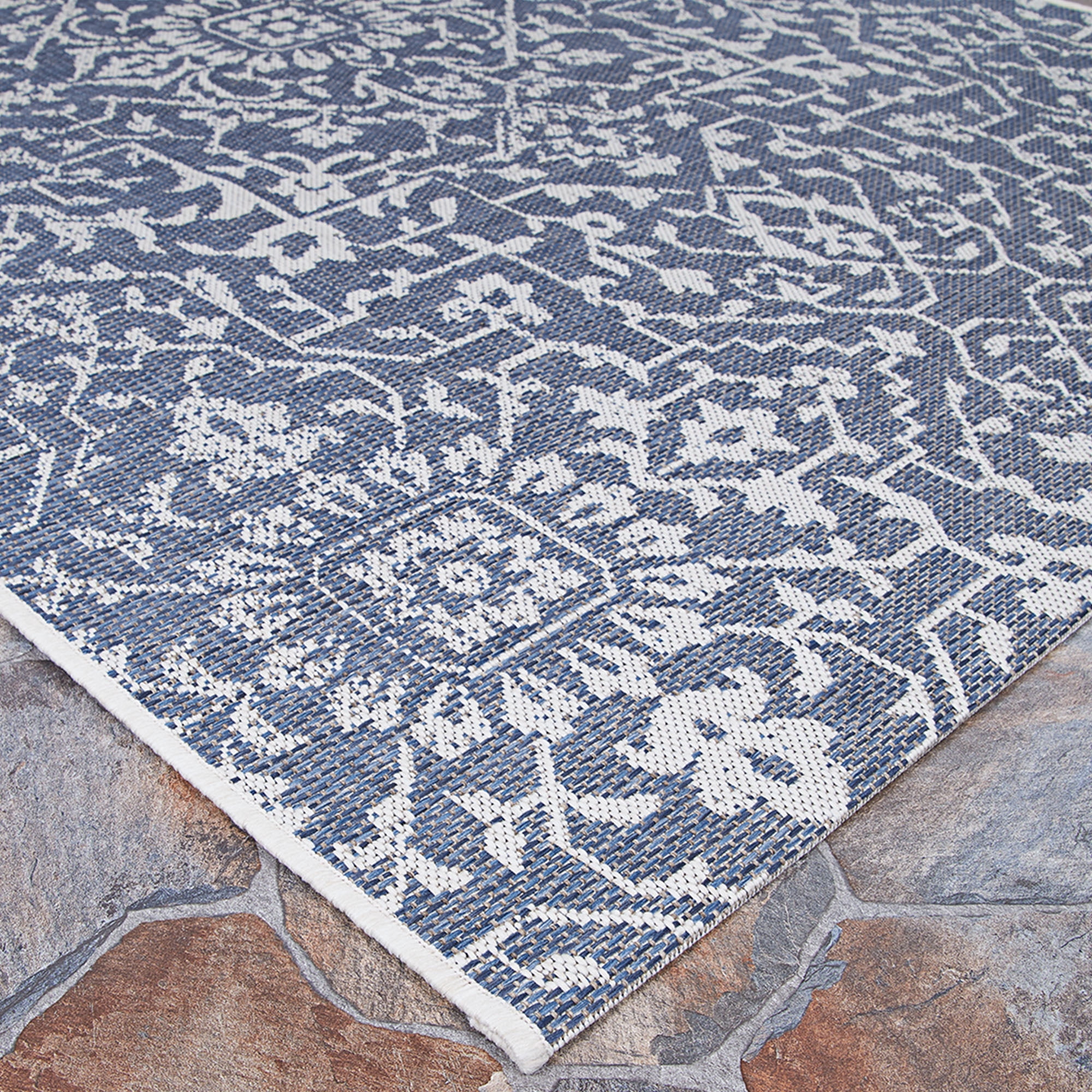 Couristan 5.5' x 9' Ocean Blue and Ivory Outdoor Floral Rectangular Area Throw Rug