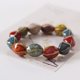 thumbnail image 4 of Paquete de 2 pulseras de cerámica coloridas, estilo étnico simple, variedad de formas, cadena de mano elástica para mujeres y niñas, 4 of 5