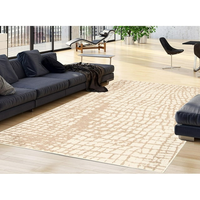 ECARPET Sisal Safari Collection indoor outdoor area rug with beige and light brown abstract pattern on wooden floor between dark sofas in a bright living room.