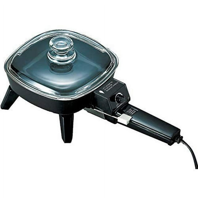 Brentwood SK-45 6-inch non-stick electric skillet with glass lid in black, featuring a compact design measuring 7.7 inches deep, 9 inches wide, and 6.6 inches high. The skillet includes a temperature control dial, sturdy legs for stability, and a transparent glass lid with a handle for easy monitoring of food. Suitable for small kitchens or quick meal preparation.
