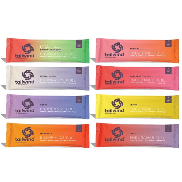 tailwind grab-and-go endurance fuel single serve assorted flavors (pack of 8) front-facing arrangement of eight colorful single-serve stick packs showing Tailwind logo and flavor names; slim packets in assorted colors labeled Endurance Fuel — hydration drink mix with electrolytes and carbohydrates, non-GMO, gluten-free, vegan, no soy or dairy; suitable for adding to a reusable bottle or hydration pack for on-the-go fueling.