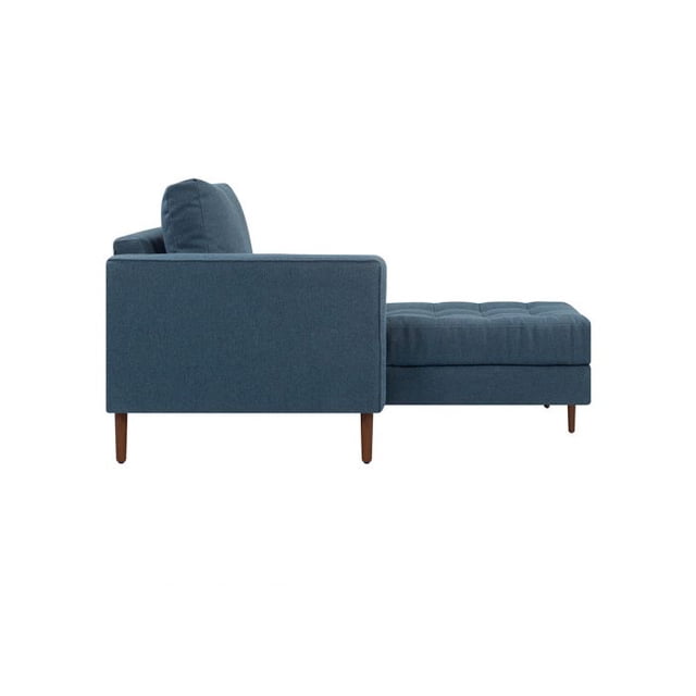 sala esquinera izquierda 4 cuerpos landero - azul vista lateral, esquinero modular con chaise a la derecha; sofá de 4 cuerpos con respaldo y cojín suelto, tapizado azul, asiento capitoné y piernas cónicas de madera oscura, silueta recta sobre fondo blanco; también suele emplearse como rincón de lectura por su chaise.