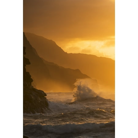 Surf breaks on the Na Pali coast at sunset Kauai Hawaii United States of America