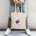 thumbnail image 2 of Stylish canvas tote bag featuring a pixelated red hat on a white print perfect for shopping travel and parties, 2 of 4