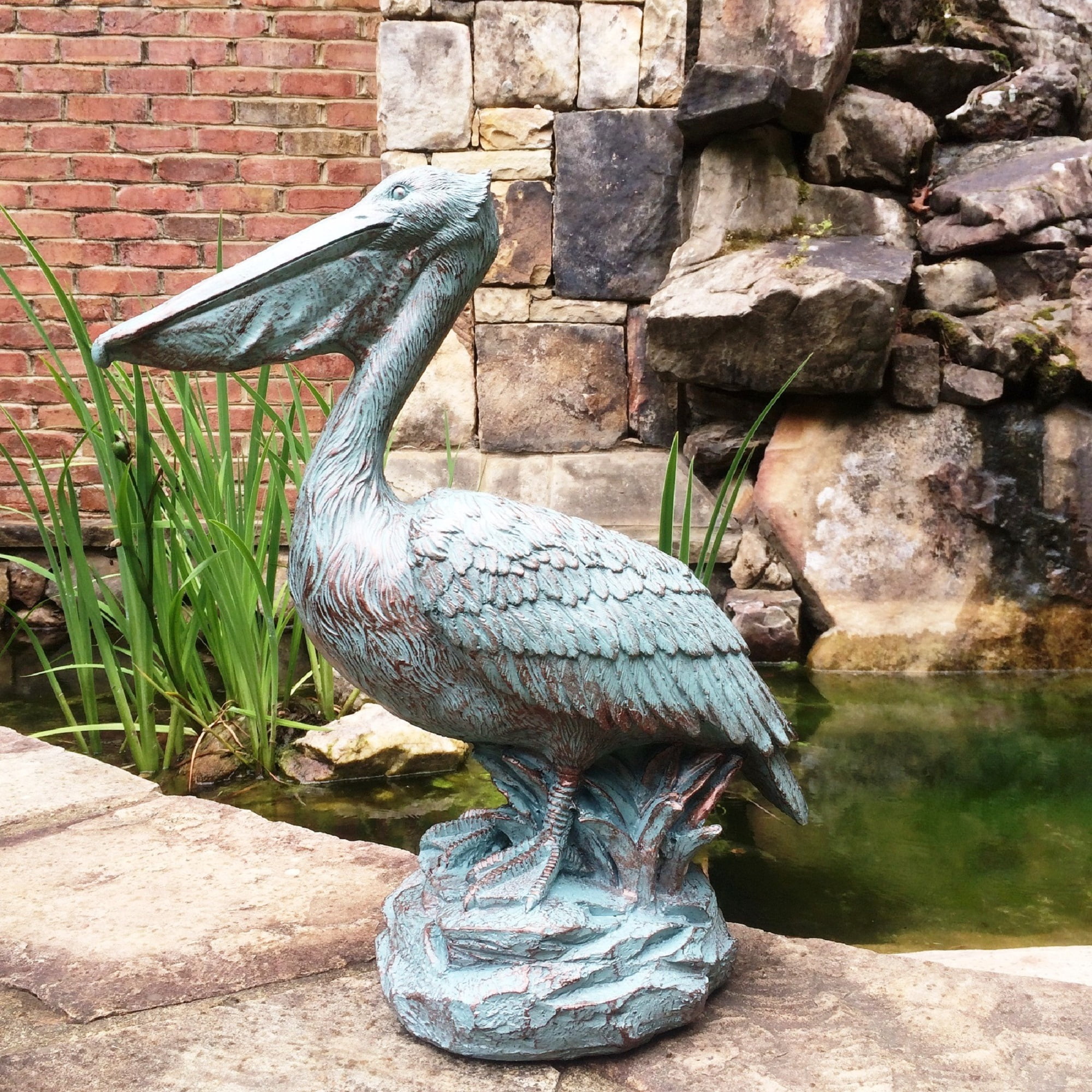 Homestyles 20 in. Bronze Patina Pelican on Coastal Rock Beach Statue