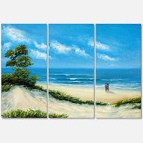 Designart ' Couple At The Beach In Sunlight ' Nautical & Coastal Canvas Wall Art Print