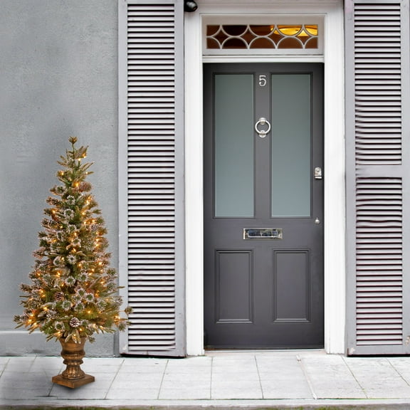 National Tree Company 4 ft. Pre-Lit Feel Real® Artificial Liberty Pine Christmas Entrance Tree, Green, Flocked, Pinecones, 100 Clear Lights, Bronze Pedestal Urn