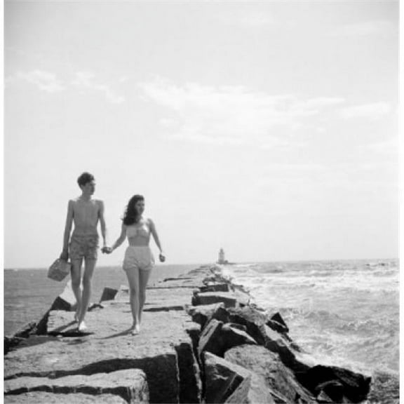 Young Couple Walking Along Groyne Poster Print - 18 x 24 in.