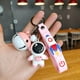 thumbnail image 1 of Llavero de astronauta con forma de campana, seguro, inodoro, de PVC, para guardar llaves. Astronauta rosa (modelo campana)., 1 of 1