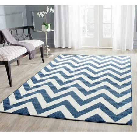 Safavieh AMHERST  NAVY / BEIGE  5  X 8   Area Rug  AMT419P-5 AMHERST  NAVY / BEIGE  5  X 8   Area Rug  AMT419P-5 Coordinate indoor and outdoor living spaces with fashion-right Amherst all-weather rugs by Safavieh. Power loomed of long-wearing polypropylene  beautiful cut pile Amherst rugs stand up to tough outdoor conditions with the aesthetics of indoor rugs. - Backing: No Backing - Color: NAVY / BEIGE - Shape: Medium Rectangle - Size: 5  X 8  - Weight: 17 - Construction: Power Loomed - Pile Height: 0.39 - Fiber/Finish: 67% Polypropylene 18% Fibrillated Polypropylene 8% Latex 7% Poly-cotton(warp)