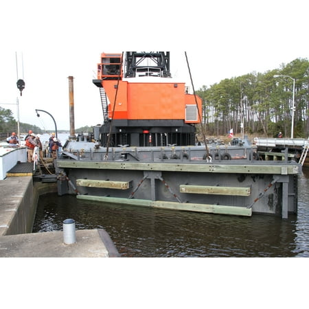 CHESAPEAKE, Va. A crane lowers one of two refurbished lock gates into place at the Great Bridge Poster Print 24 x (Best Place To Get A Va Home Loan)