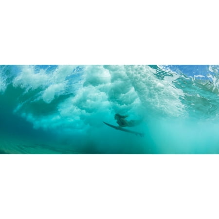 Female surfer pushes under a wave while surfing Clansthal South Africa Stretched Canvas - Panoramic Images (36 x