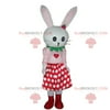 White rabbit REDBROKOLY mascot with a polka dot skirt, plush rabbit