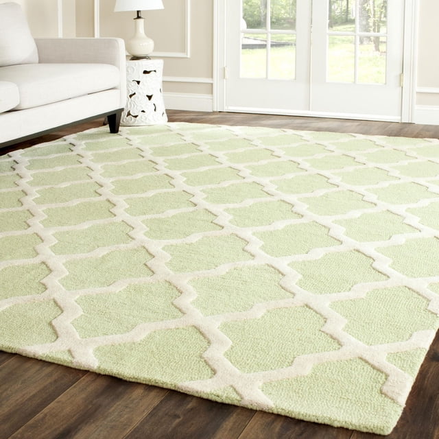 Safavieh Cambridge Liam light green area rug with white geometric trellis pattern displayed in a bright living room.
