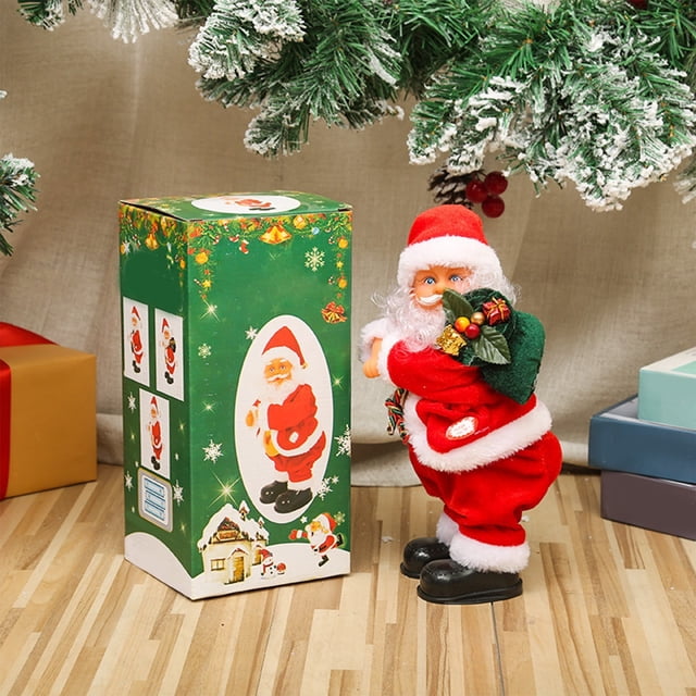 adornos navideños, papá noel bailarín con música, muñeco eléctrico de plástico de papá noel, ideal para escaparates de jugueterías — Papá Noel de plástico 26x12x12cm en traje rojo con gorro y barba blanca pintada, sostiene bolsa verde con mini regalos, base negra para giro de cadera y música integrada; caja verde ilustrada al lado; apto 3+, requiere 3 pilas AA (no incluidas); ideal para decorar vitrinas y escaparates.