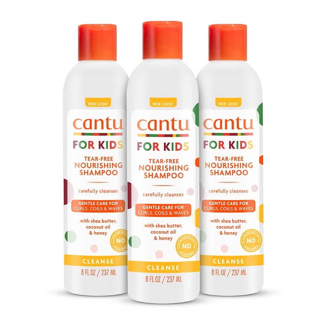 cantu care for kids tear-free nourishing shampoo with shea butter, 8 fl oz (pack of 3) (packaging may vary) Tres botellas blancas verticales con tapa naranja, vista frontal de la etiqueta 'cantu for kids' y 'tear-free nourishing shampoo', acentos naranjas y amarillos, indica 8 fl oz / 237 ml cada una, fondo blanco; también apto como champú de viaje suave para cabello texturizado infantil.