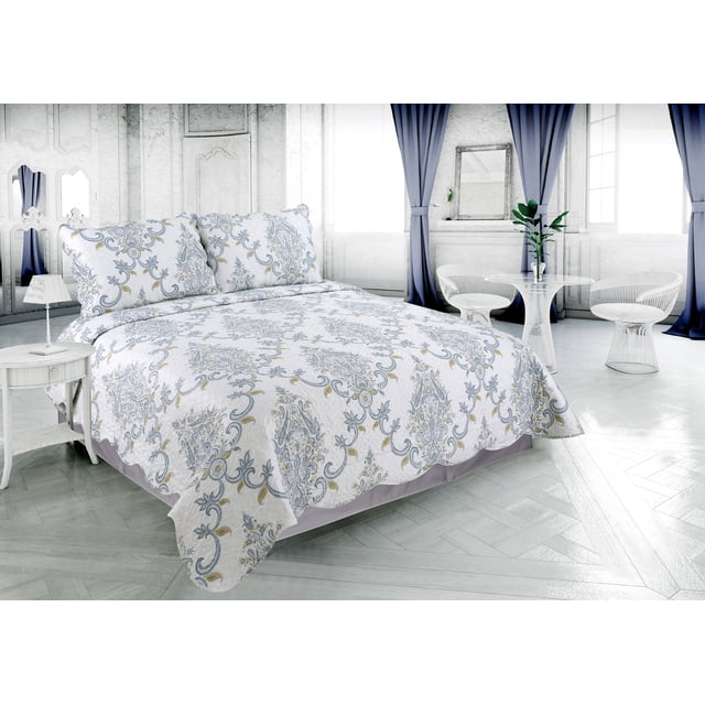 ultra soft quilt set featuring classic blue and yellow paisley printed stitching coverlet with matching quilted shams displayed on a bed in a modern white bedroom
