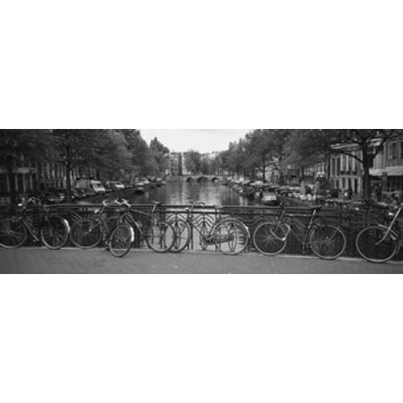 Bicycle Leaning Against A Metal Railing On A Bridge Amsterdam Netherlands Stretched Canvas - Panoramic Images (36 x