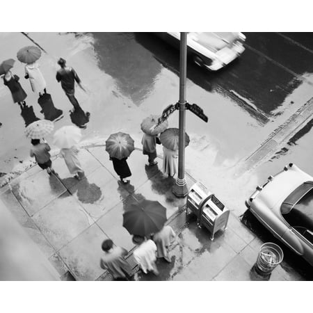 - 1950s Aerial Of Street Corner In The Rain Pedestrians With Umbrellas Cars Wet Pavement Park Ave & 48Th Street New York