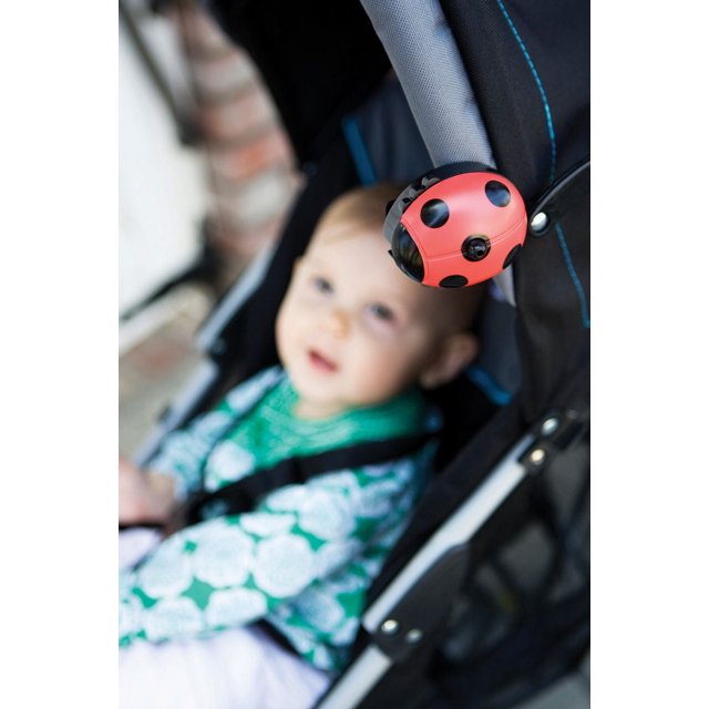 Prince Lionheart loveBUG Repellent clipped to a black stroller with blue stitching, showing the red and black ladybug-shaped electronic mosquito repellent that emits a safe, low-level tone mimicking a dragonfly’s wing beat to repel mosquitoes, ideal for outdoor insect control.