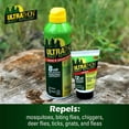 A bottle of Ultrathon mosquito repellent cream is displayed alongside a smaller container of repellent, set outdoors on a rocky surface amidst green foliage.