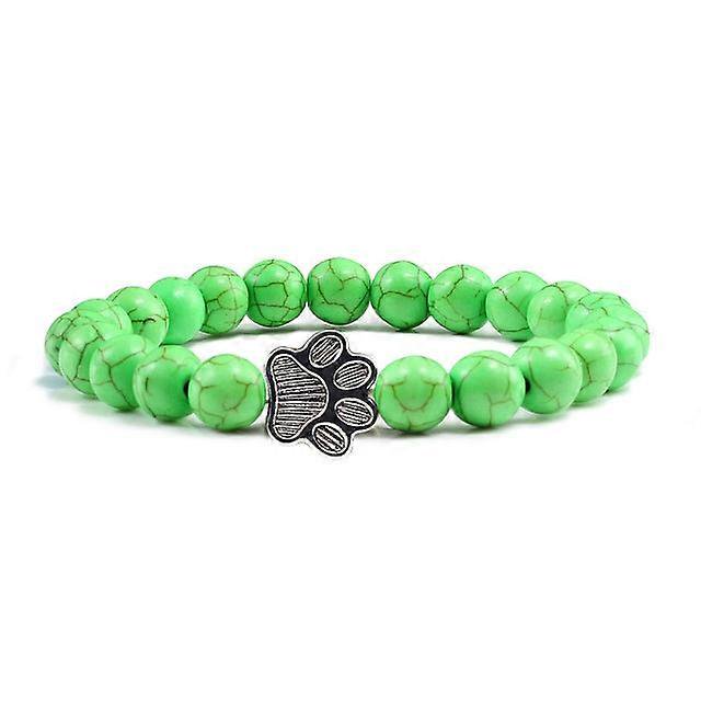Pulsera con dije de huella de pata de piedra volcánica de lava negra mate natural, ideal como recuerdo para mascotas, amantes de los gatos y los perros.
