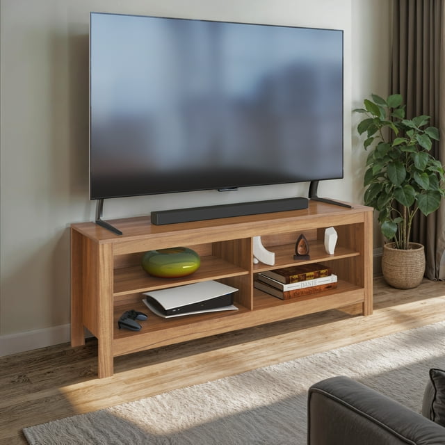 CorLiving Norio faux wood TV stand with 4 open shelves displaying books, decor, and gaming console beneath a large flat-screen television.