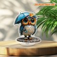 thumbnail image 4 of Rotating acrylic ornament featuring a colorful glass owl with a rain hat and umbrella, wearing a cyan raincoat on a cobblestone road, 4 of 8