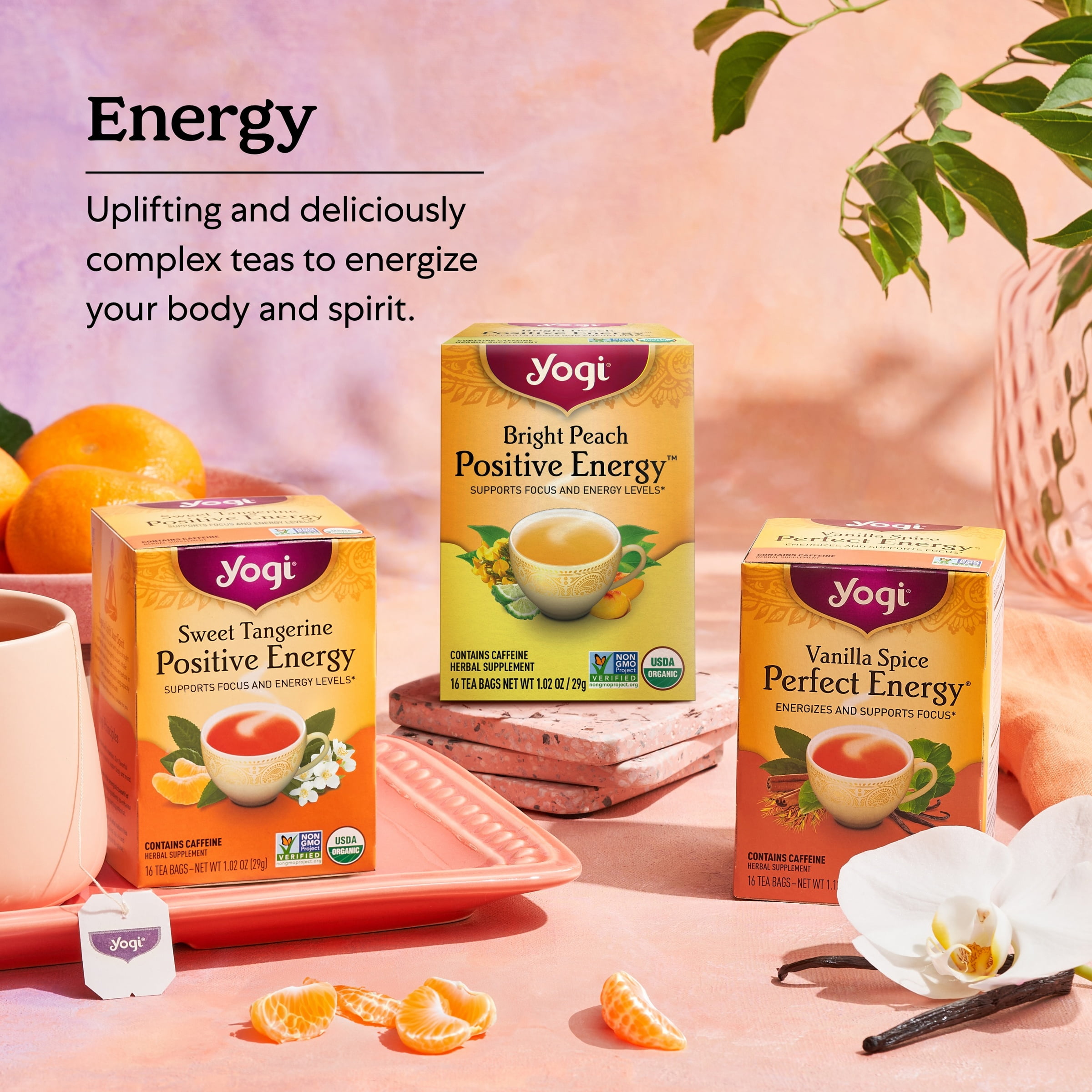 A wellness setup with a cup of green vanilla tea, fresh vanilla beans, and green tea leaves alongside a yoga mat and essential oils